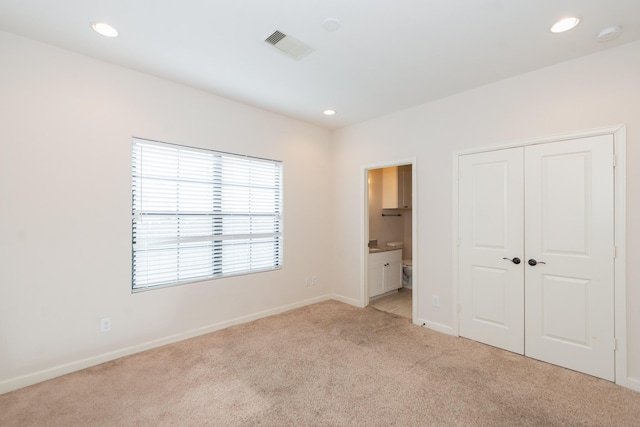 1404 W 26th St Unit C, Houston, TX 77008 - unfurnished bedroom with light colored carpet, baseboards, recessed lighting, a closet, and ensuite bathroom