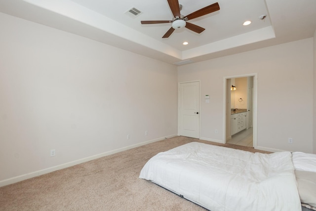 1404 W 26th St Unit C, Houston, TX 77008 - bedroom featuring recessed lighting, light carpet, baseboards, a tray ceiling, and connected bathroom