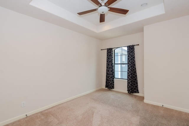 1404 W 26th St Unit C, Houston, TX 77008 - empty room with a tray ceiling, light carpet, baseboards, and a ceiling fan