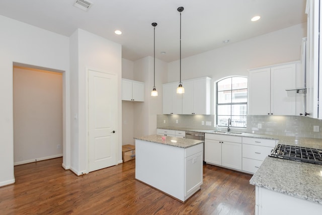 1404 W 26th St Unit C, Houston, TX 77008 - kitchen with a sink, backsplash, a center island, dark wood-style flooring, and white cabinets