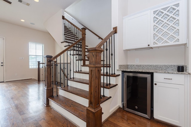 1404 W 26th St Unit C, Houston, TX 77008 - stairway featuring beverage cooler, a bar, wood finished floors, recessed lighting, and baseboards