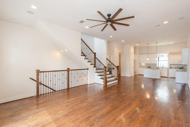 1404 W 26th St Unit C, Houston, TX 77008 - unfurnished living room with a ceiling fan, wood finished floors, recessed lighting, and stairs