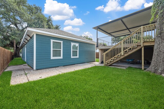 7024 Avenue Ave E, Houston, TX 77011 - back of property with stairs, a wooden deck, and a patio area