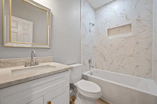 7024 Avenue Ave E, Houston, TX 77011 - bathroom featuring vanity, toilet, bathtub / shower combination, wood finished floors, and a textured wall