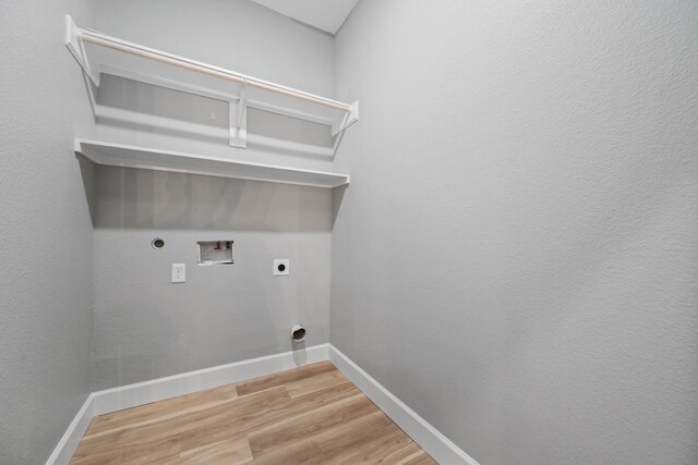 7024 Avenue Ave E, Houston, TX 77011 - washroom with hookup for an electric dryer, washer hookup, light wood-type flooring, and baseboards