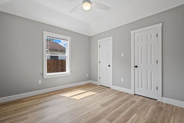 7024 Avenue Ave E, Houston, TX 77011 - unfurnished bedroom with light wood-style floors, baseboards, and a ceiling fan