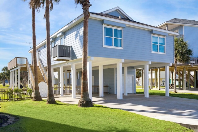 4014 Warchest Ct, Galveston, TX 77554 - view of front facade with a carport, concrete driveway, and stairs