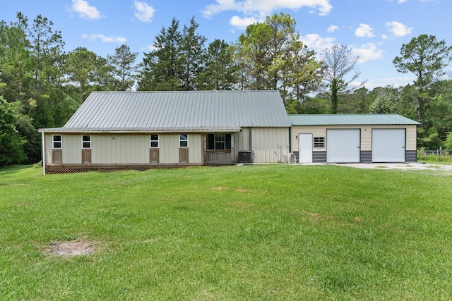 9 Wood Forest Dr, New Waverly, TX 77358 - view of front of property featuring central air condition unit, a front lawn, metal roof, and board and batten siding