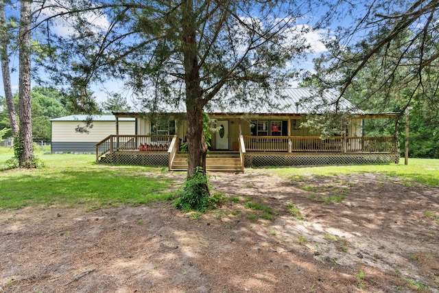 9 Wood Forest Dr, New Waverly, TX 77358 - rear view of property featuring a yard and a wooden deck
