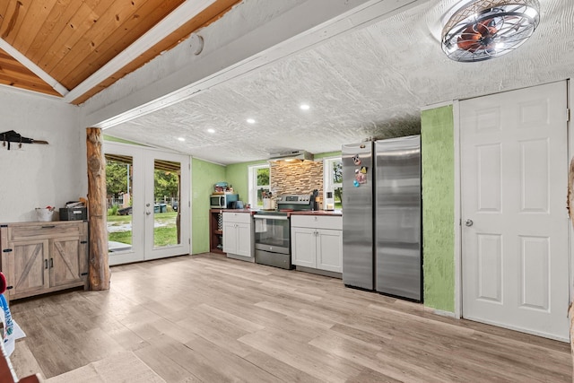 9 Wood Forest Dr, New Waverly, TX 77358 - kitchen with stainless steel appliances, french doors, plenty of natural light, light wood finished floors, and wood ceiling