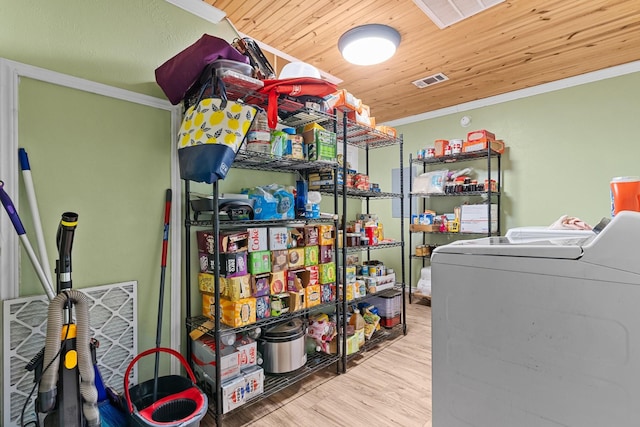 9 Wood Forest Dr, New Waverly, TX 77358 - laundry area featuring wood finished floors, independent washer and dryer, and crown molding