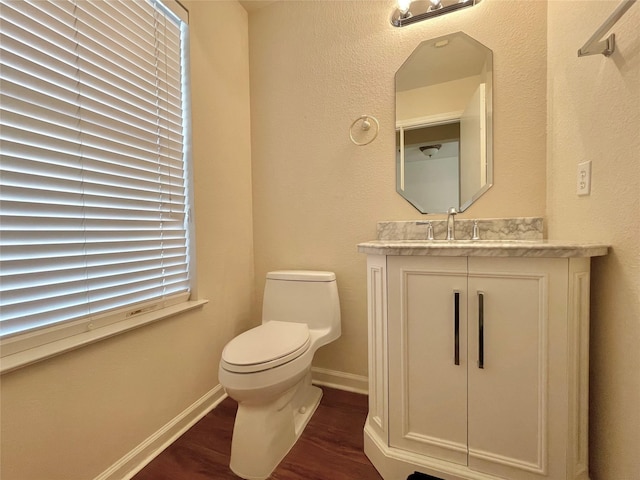 21807 Olympia Springs Ln, Katy, TX 77449 - half bathroom featuring wood finished floors, toilet, vanity, and baseboards