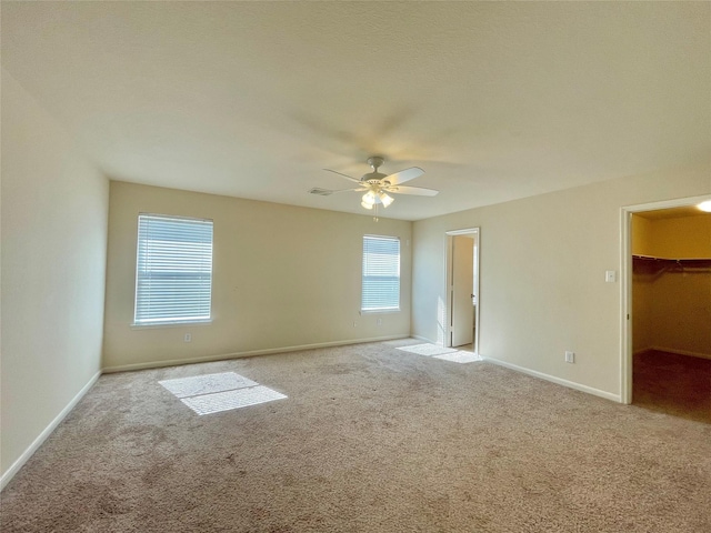 21807 Olympia Springs Ln, Katy, TX 77449 - unfurnished bedroom featuring carpet, a spacious closet, baseboards, and a ceiling fan