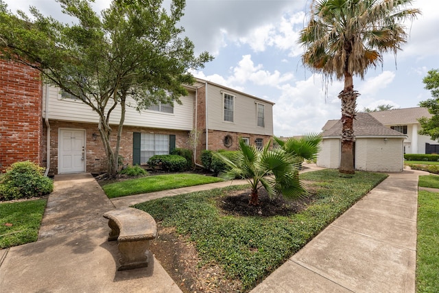 14721 Perthshire Rd, Houston, TX 77079 - view of property featuring brick siding and a front yard
