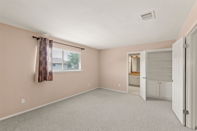 14721 Perthshire Rd, Houston, TX 77079 - unfurnished bedroom with light colored carpet, baseboards, and ensuite bath