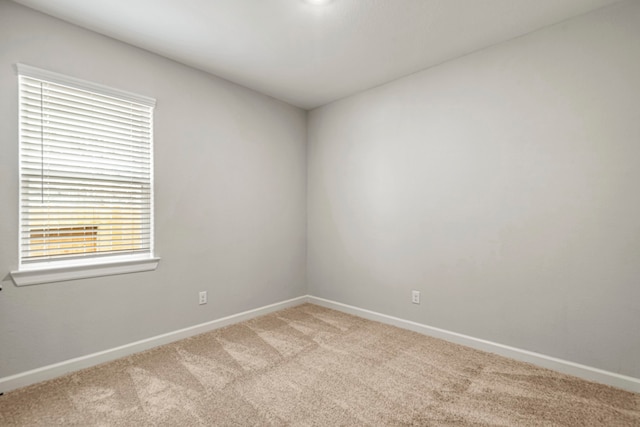 15679 Honey Cove Dr, Conroe, TX 77303 - spare room with light colored carpet and baseboards