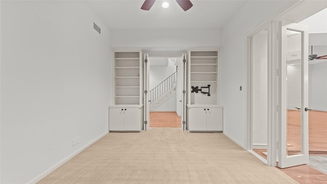 4868 Post Oak Timber Dr, Houston, TX 77056 - unfurnished bedroom with light carpet, a walk in closet, a ceiling fan, and connected bathroom