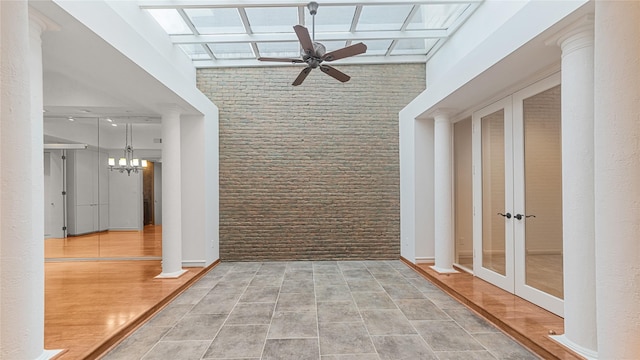 4868 Post Oak Timber Dr, Houston, TX 77056 - hall featuring a towering ceiling, french doors, a chandelier, and wood finished floors
