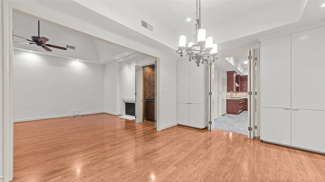 4868 Post Oak Timber Dr, Houston, TX 77056 - unfurnished dining area featuring a fireplace, light wood-type flooring, ceiling fan, recessed lighting, and a chandelier