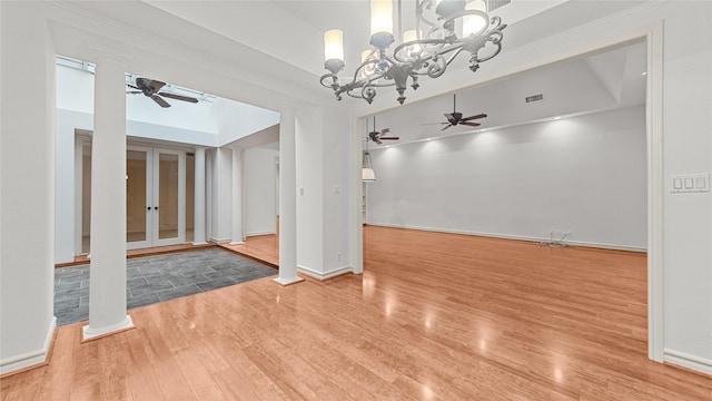 4868 Post Oak Timber Dr, Houston, TX 77056 - spare room with a ceiling fan, wood finished floors, decorative columns, and a chandelier