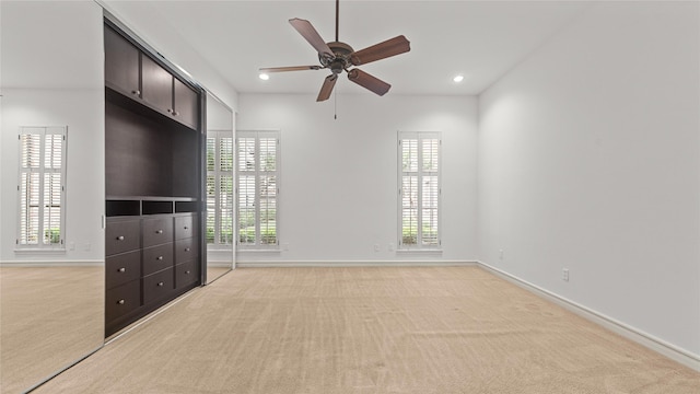 4868 Post Oak Timber Dr, Houston, TX 77056 - unfurnished bedroom with light colored carpet, multiple windows, recessed lighting, and ceiling fan