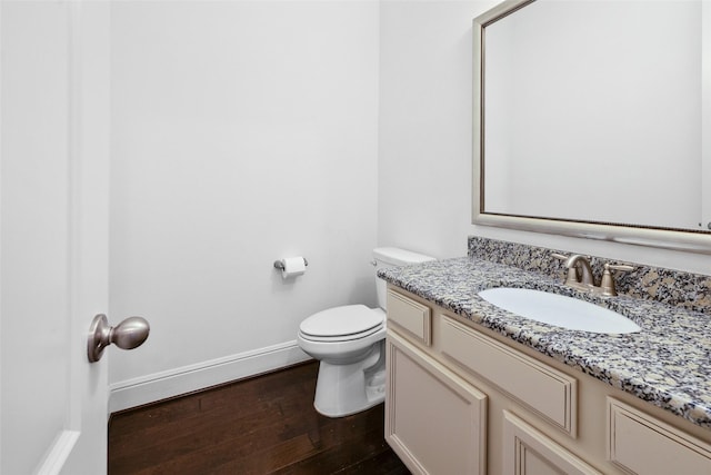 211 Twilight Toast Dr, Conroe, TX 77304 - bathroom with baseboards, wood finished floors, vanity, and toilet