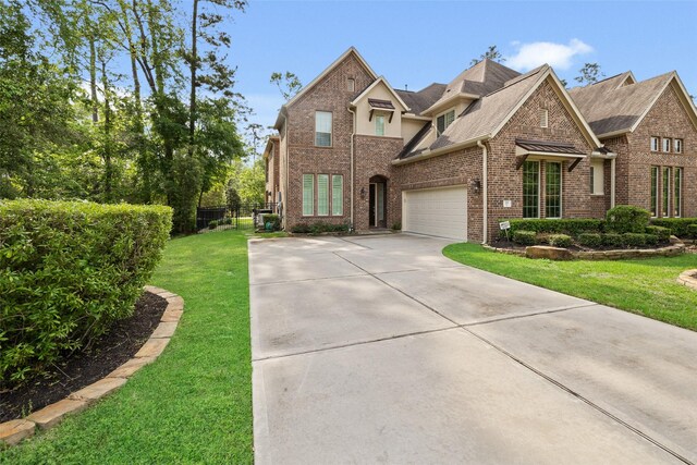 211 Twilight Toast Dr, Conroe, TX 77304 - traditional-style home featuring driveway, brick siding, and roof with shingles
