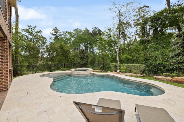 211 Twilight Toast Dr, Conroe, TX 77304 - view of swimming pool featuring a patio, a pool with connected hot tub, and view of wooded area