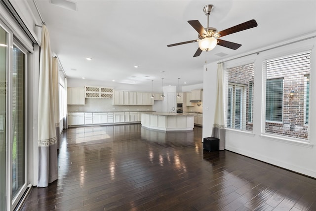 211 Twilight Toast Dr, Conroe, TX 77304 - unfurnished living room with healthy amount of natural light, ceiling fan, dark wood-type flooring, recessed lighting, and a sink