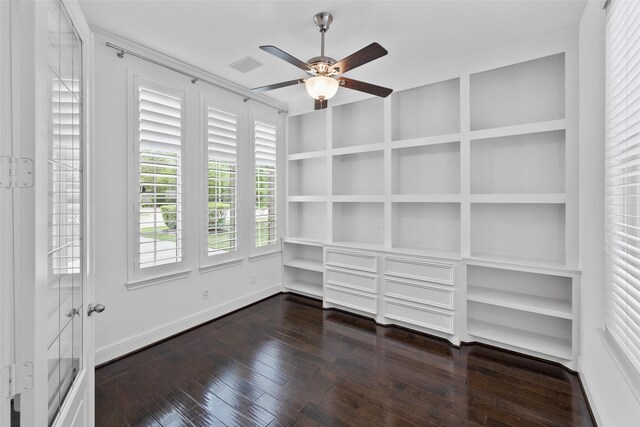 211 Twilight Toast Dr, Conroe, TX 77304 - unfurnished room featuring built in shelves, dark wood-type flooring, a ceiling fan, and baseboards