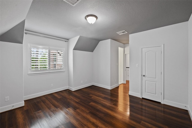 211 Twilight Toast Dr, Conroe, TX 77304 - additional living space featuring wood finished floors, a textured ceiling, lofted ceiling, and baseboards