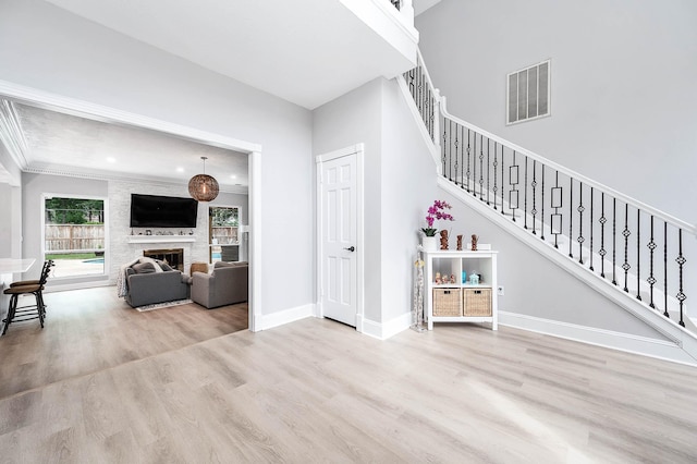 17706 August Meadows Ln, Spring, TX 77379 - living area with wood finished floors, stairway, baseboards, a fireplace, and ornamental molding