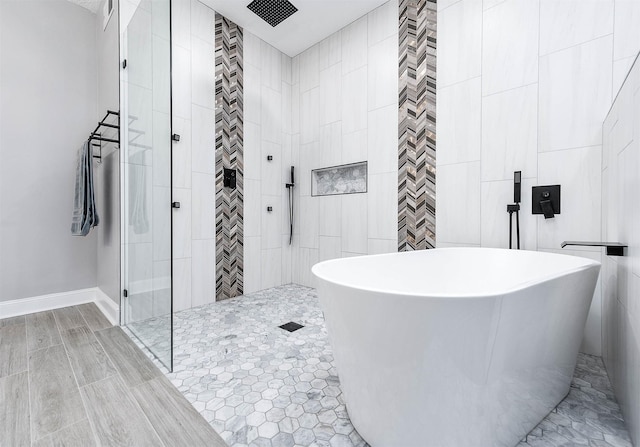 17706 August Meadows Ln, Spring, TX 77379 - full bathroom with a walk in shower, a freestanding tub, and baseboards