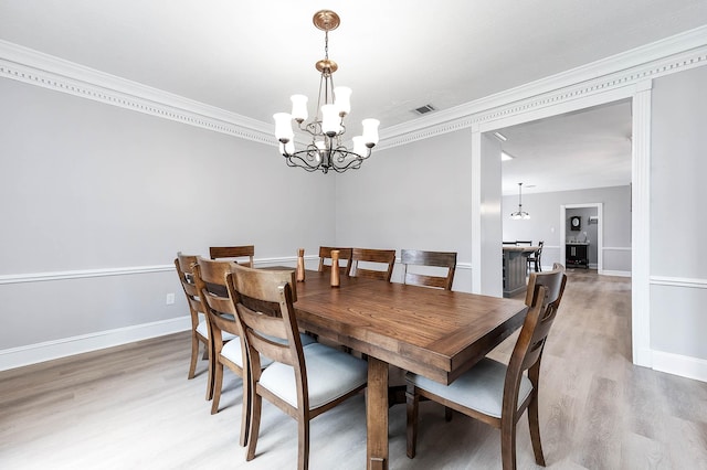 17706 August Meadows Ln, Spring, TX 77379 - dining room featuring a chandelier, crown molding, light wood-style flooring, and baseboards