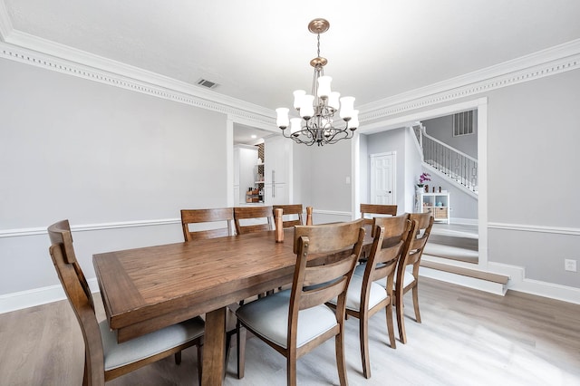 17706 August Meadows Ln, Spring, TX 77379 - dining area with stairway, crown molding, a chandelier, light wood-style flooring, and baseboards