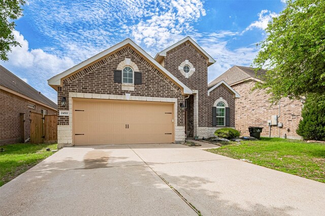24511 Peroni Dr, Richmond, TX 77406 - traditional-style house featuring a garage, brick siding, driveway, and stone siding