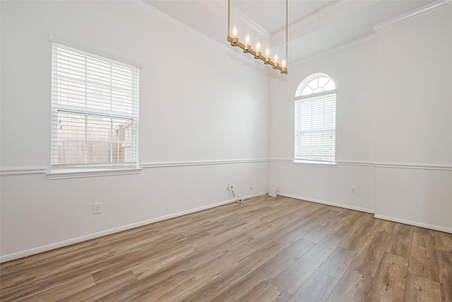 24511 Peroni Dr, Richmond, TX 77406 - spare room featuring ornamental molding, wood finished floors, baseboards, and a chandelier