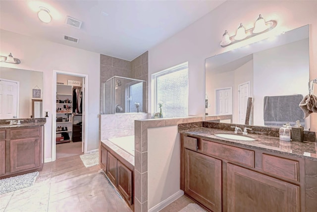 24511 Peroni Dr, Richmond, TX 77406 - full bathroom featuring a shower stall, two vanities, a walk in closet, and a bath