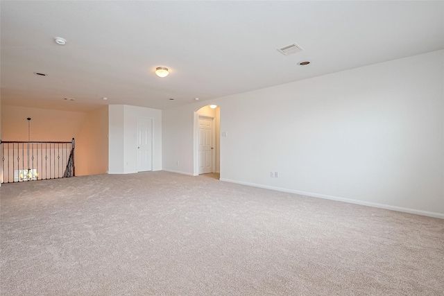 24511 Peroni Dr, Richmond, TX 77406 - empty room with arched walkways, light carpet, baseboards, and a smoke detector