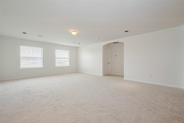 24511 Peroni Dr, Richmond, TX 77406 - unfurnished room with arched walkways, light carpet, and baseboards