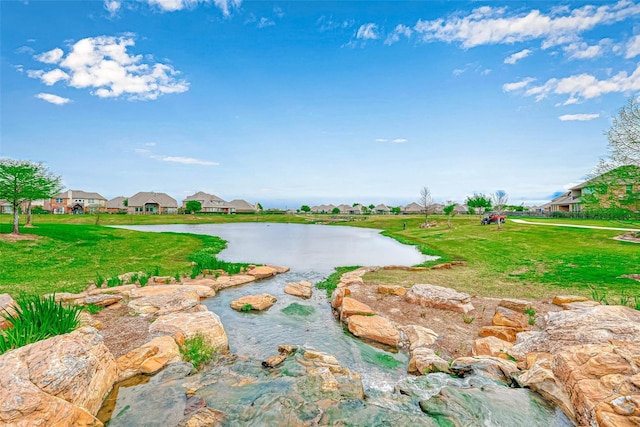 24511 Peroni Dr, Richmond, TX 77406 - view of community featuring a residential view, a lawn, and a water view