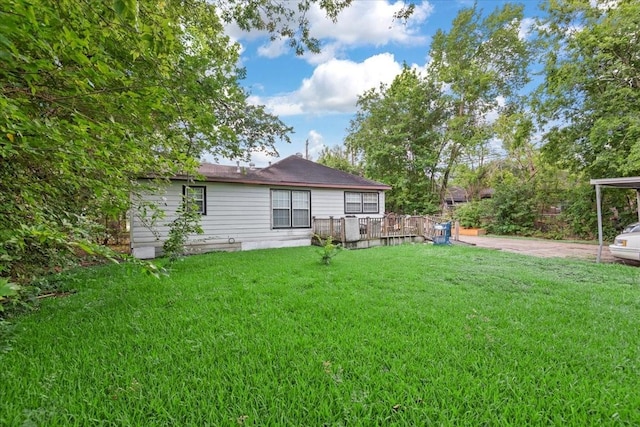 315 E Whitney St, Houston, TX 77022 - rear view of house with a lawn, a deck, and a carport