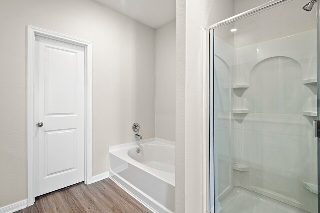 15695 Honey Cove Dr, Conroe, TX 77303 - full bath with a stall shower, a garden tub, wood finished floors, and baseboards