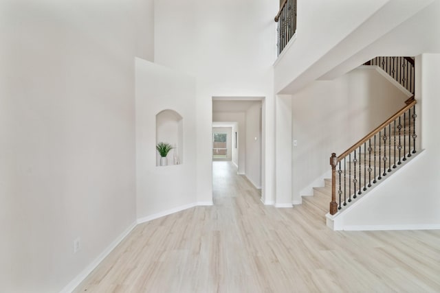 4010 Loft Square Pl, Humble, TX 77346 - entryway featuring a high ceiling, wood finished floors, stairs, and baseboards