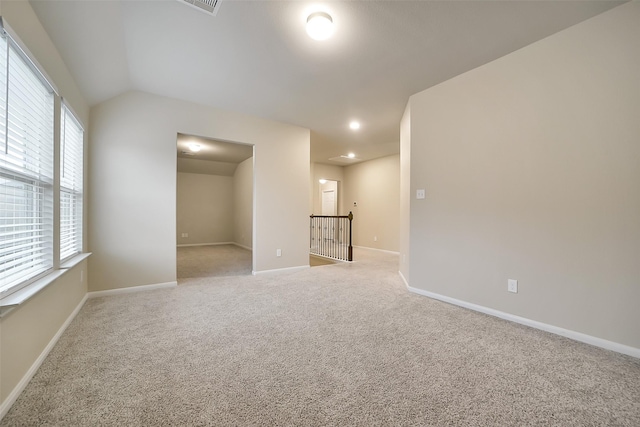 4502 Kayden Berry Ct, Rosenberg, TX 77471 - empty room featuring light carpet, baseboards, and vaulted ceiling