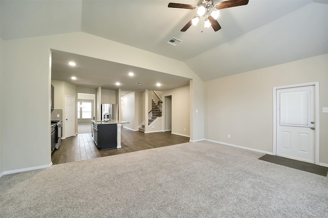 4502 Kayden Berry Ct, Rosenberg, TX 77471 - unfurnished living room featuring dark carpet, vaulted ceiling, stairs, ceiling fan, and baseboards
