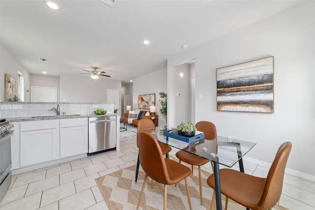 25807 Boxwood Hedge Ln, Tomball, TX 77375 - kitchen with stainless steel appliances, a sink, tasteful backsplash, white cabinetry, and ceiling fan