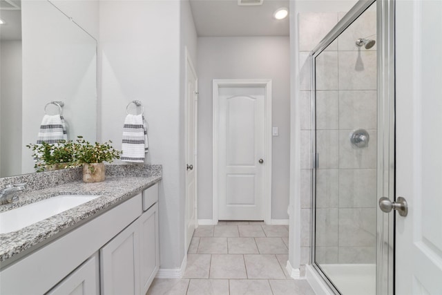 25807 Boxwood Hedge Ln, Tomball, TX 77375 - full bathroom featuring a stall shower, vanity, tile patterned flooring, and baseboards