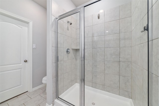25807 Boxwood Hedge Ln, Tomball, TX 77375 - bathroom with a stall shower, toilet, tile patterned floors, and baseboards