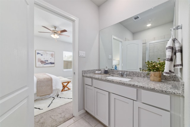 25807 Boxwood Hedge Ln, Tomball, TX 77375 - ensuite bathroom featuring vanity, a shower stall, a ceiling fan, baseboards, and tile patterned floors